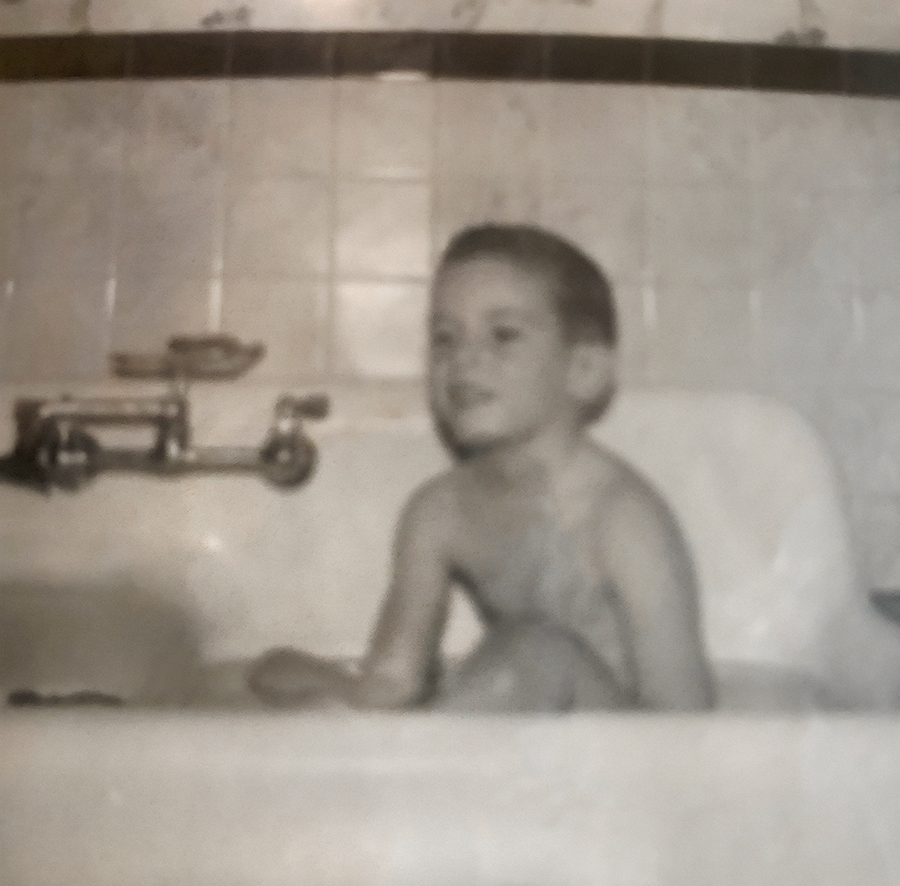 Will as a toddler bathing in his godparents' sink