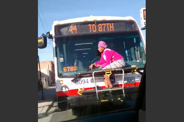 Woman riding on bike rack on CTA bus
